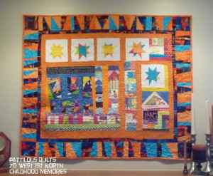 P Ferguson artist. "I made this quilt last summer as part of a challenge.  The border needed to be something special and then I found that wonderful Robert Kaufman fabric that I'd purchased from you, but hated to cut into it because it was so pretty.  When I thought about how fun the border would be that fear of the first cut went away.  The quilt is called 70 W 1st North.  It has semblance of the house I lived in as a child and the house with the heart in the window is where I was welcomed to visit. "  